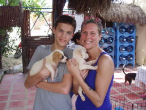 Mason and Sonyia Steen holding two puppies at the shelter